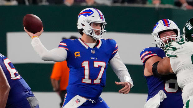 Mitch Morse blocking for Josh Allen as he throws a pass in Week 1 vs. the New York Jets.